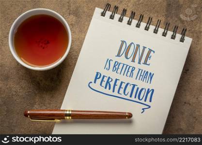 Done is better than perfection reminder - handwriting in a spiral notebook with a cup of tea, business, efficiency and productivity concept