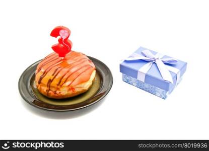 donut with three years birthday candle and gift on white