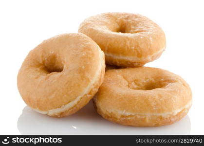 Donuts on a white reflective background.