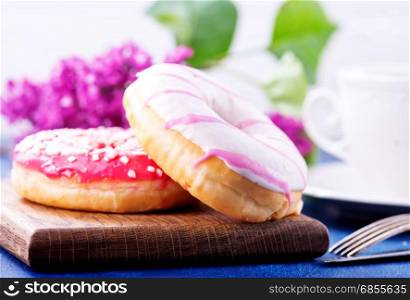 donuts on wooden board and on a table