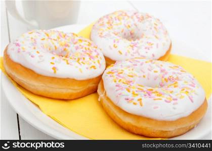 Donuts With Colorful Sprinkles, Plates and Mugs on Table