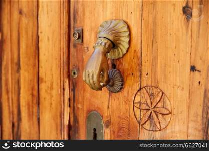 Door brass knock hand shape in Mediterranean Spain