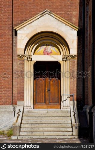 door in italy lombardy column the milano old church closed brick pavement