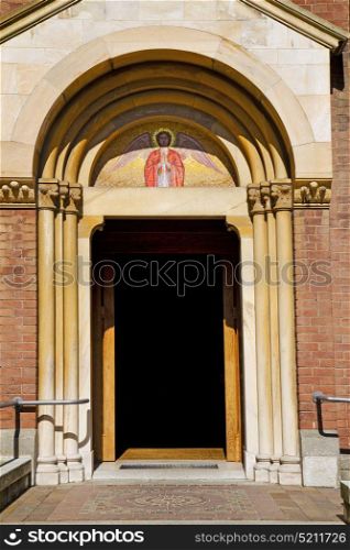 door in italy lombardy column the milano old church closed brick pavement