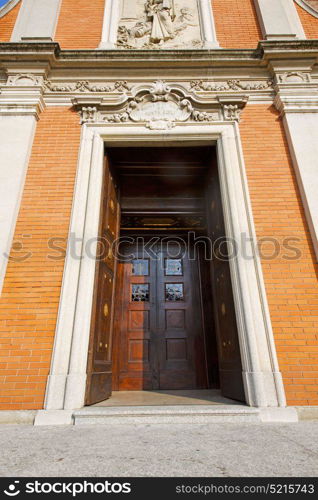 door in italy lombardy column the milano old church closed brick pavement