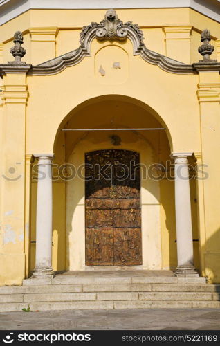 door in italy lombardy column the milano old church closed brick pavement