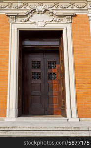 door in italy lombardy column the milano old church closed brick pavement