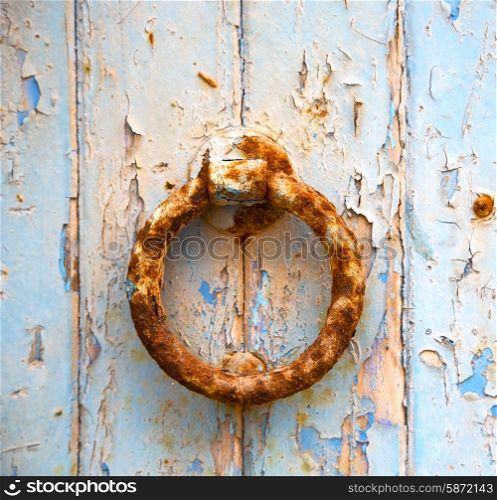 door knocker and blue rusty wood