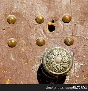 door knocker and brown rusty wood