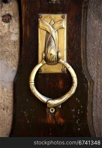 door knocker-gold. golden brown door and door knocker