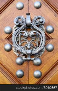 Door knocker in the form of woman with wings