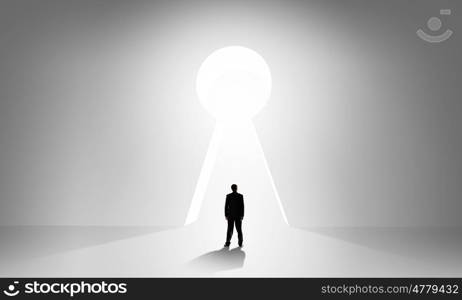 Door to new opportunities. Back view of businessman standing in keyhole doorway
