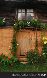 Door, window and flowers of old village house