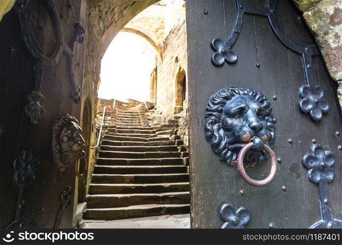 Door with lions, old provincial European town. Summer tourism and travels, famous europe landmark, popular places for vacation tour or holidays