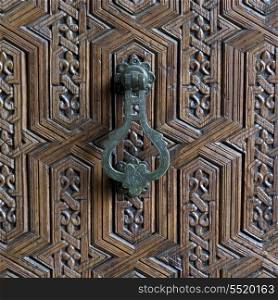 Doorknocker and carved detail of a door, Marrakesh Museum, Medina, Marrakesh, Morocco