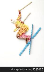 Doping pills and drugs in the shape of a winter jumping skier.