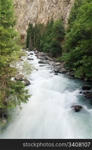 Dora stream between rocks in Pre Saint Didier, Aosta. Italy