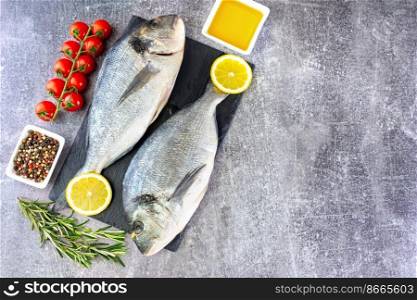 Dorado fish on gray concrete background with copy space. Sea food with ingredients for cooking. Delicacy spices and vegetables. Banner, header, background for menu and restaurant recipe