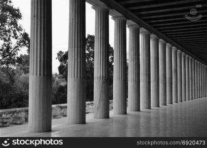 Doric columns in stoa of attalos covered walkway in the ancient agora of Athens, Greece. Black and white.