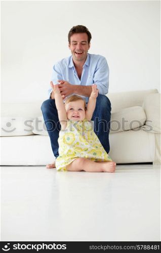Doting father with baby daughter at home