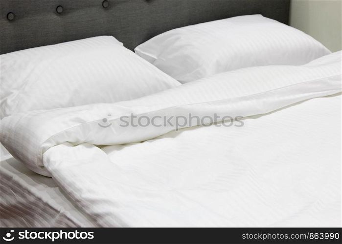 Double bed with a fresh white bedding.