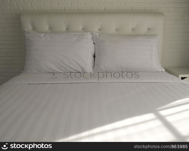 Double bedroom with white pillows and blanket.