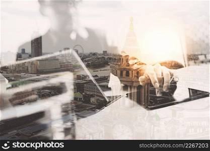 Double exposure,Businessman hand touching digital tablet.Photo finance manager working new Investment project office,London city