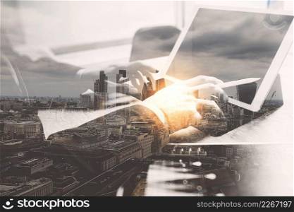 Double Exposure,Businessman hand working concept. Documents finance graphic chart. Digital tablet keyboard dock screen computer design smart phone using