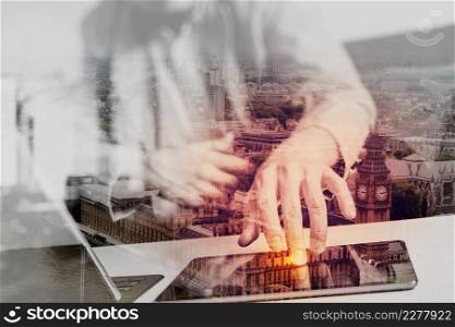 double exposure,hipster hand using smart phone,digital tablet docking keyboard,coffee cup, payments online business,sitting on sofa in living room,work at home concept,London architecture city