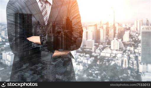 Double Exposure Image of Business Person on modern city background. Future business and communication technology concept. Surreal futuristic cityscape and abstract multiple exposure graphic interface.