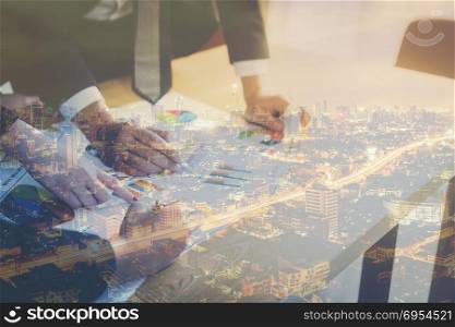 Double Exposure of a business teamwork concept with city night background