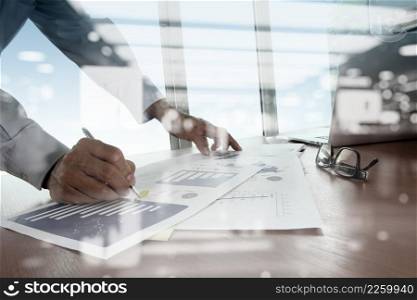 double exposure of business documents on office table with smart phone and digital tablet and stylus and two colleagues discussing data in the background