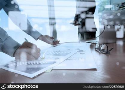 double exposure of business documents on office table with smart phone and digital tablet and stylus and two colleagues discussing data in the background