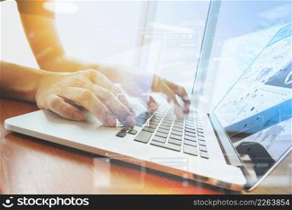 Double exposure of business man hand working on laptop computer with business strategy diagram on wooden desk as concept