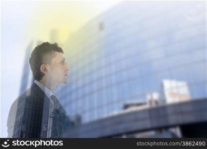 Double exposure of business man with office building