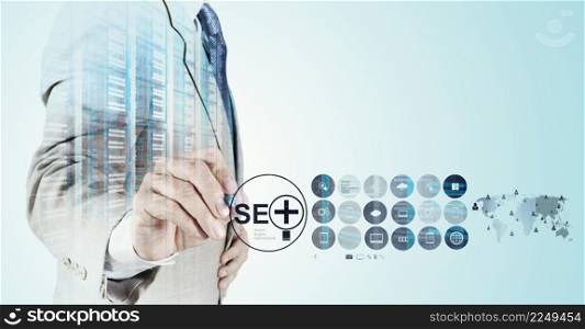 Double exposure of businessman hand showing search engine optimization SEO as concept