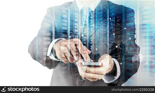 Double exposure of Businessman hand using mobile phone and server room as concept