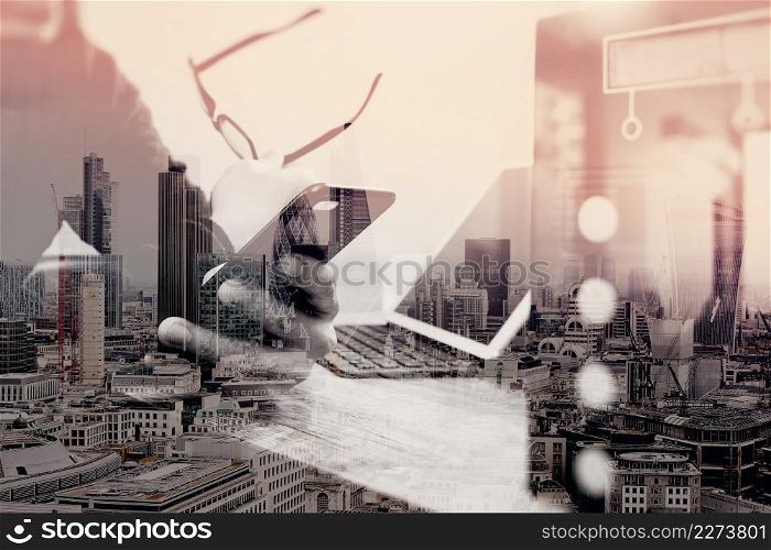 double exposure of businessman hand using smart phone,mobile payments online shopping,omni channel,digital tablet docking keyboard computer,compact server on wooden desk,London architecture city
