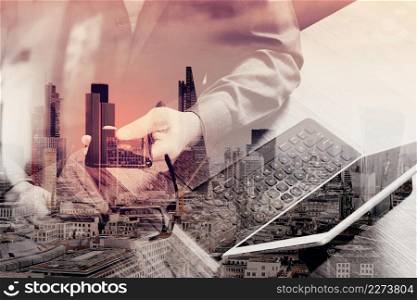 double exposure of businessman hand using smart phone,mobile payments online shopping,omni channel,digital tablet docking keyboard computer,eyeglasses,in modern office on wooden desk,London architecture city