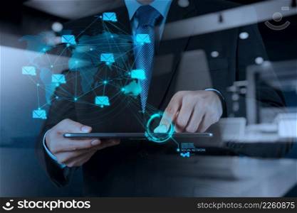 double exposure of businessman hand using tablet computer shows social network concept
