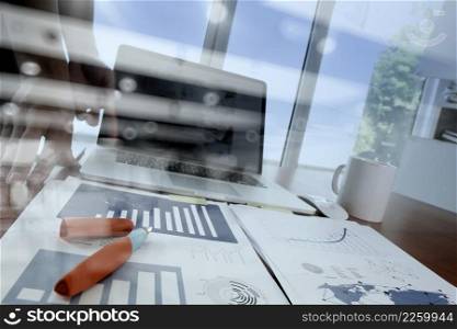 double exposure of businessman hand working with business documents on office table with laptop computer with social media diagram