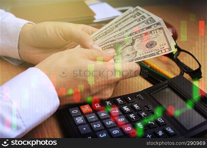 Double exposure of businessman use Counting dollar money with stock market or financial graph for financial investment concept.