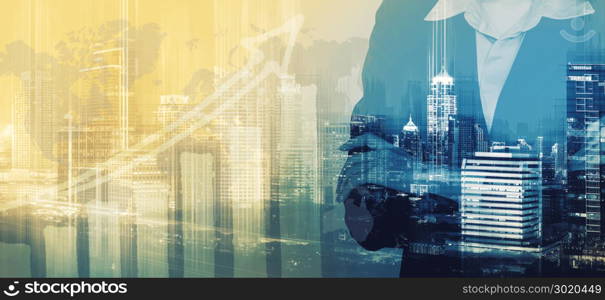Double exposure of businesswoman arms crossed and urban building background with business graph. Abstract business blurred background.