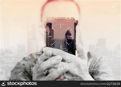 Double exposure of Designer hand using mobile payments online shopping,omni channel,in modern office wooden desk,London city buildings,eyeglass