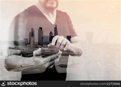 Double Exposure of Designer hand using mobile payments online shopping,omni channel,on white background,front view,London architecture buildings