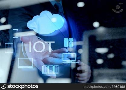 double exposure of hand showing Internet of things  IoT  word diagram as concept