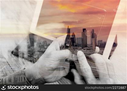Double exposure of Hand using smart phone payments online shopping,omni channel,icon customer network,in modern office wooden desk,London city buildings