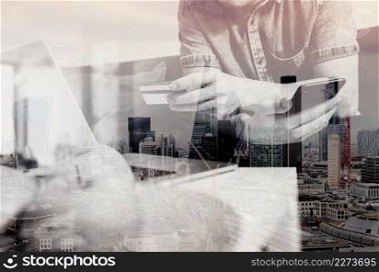 double exposure of hipster hand using smart phone and laptop compter,holding cradit card payments online business,sitting on sofa in living room,green apples in wooden tray,London city buildings