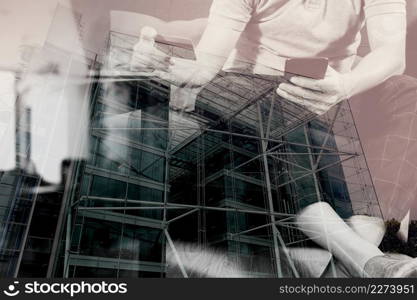 double exposure of hipster hand using smart phone,digital tablet docking keyboard,holding cradit card payments online business,sitting on sofa in living room,work at home concept,London architecture city