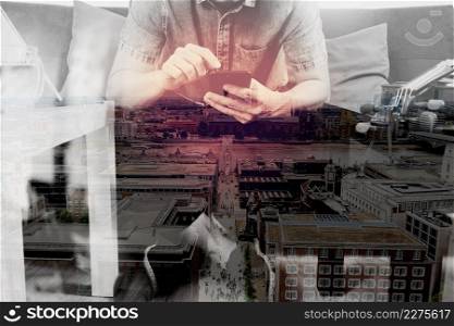 double exposure of hipster hand using smart phone,digital tablet docking keyboard,holding cradit card payments online business,sitting on sofa in living room,work at home concept,London architecture city